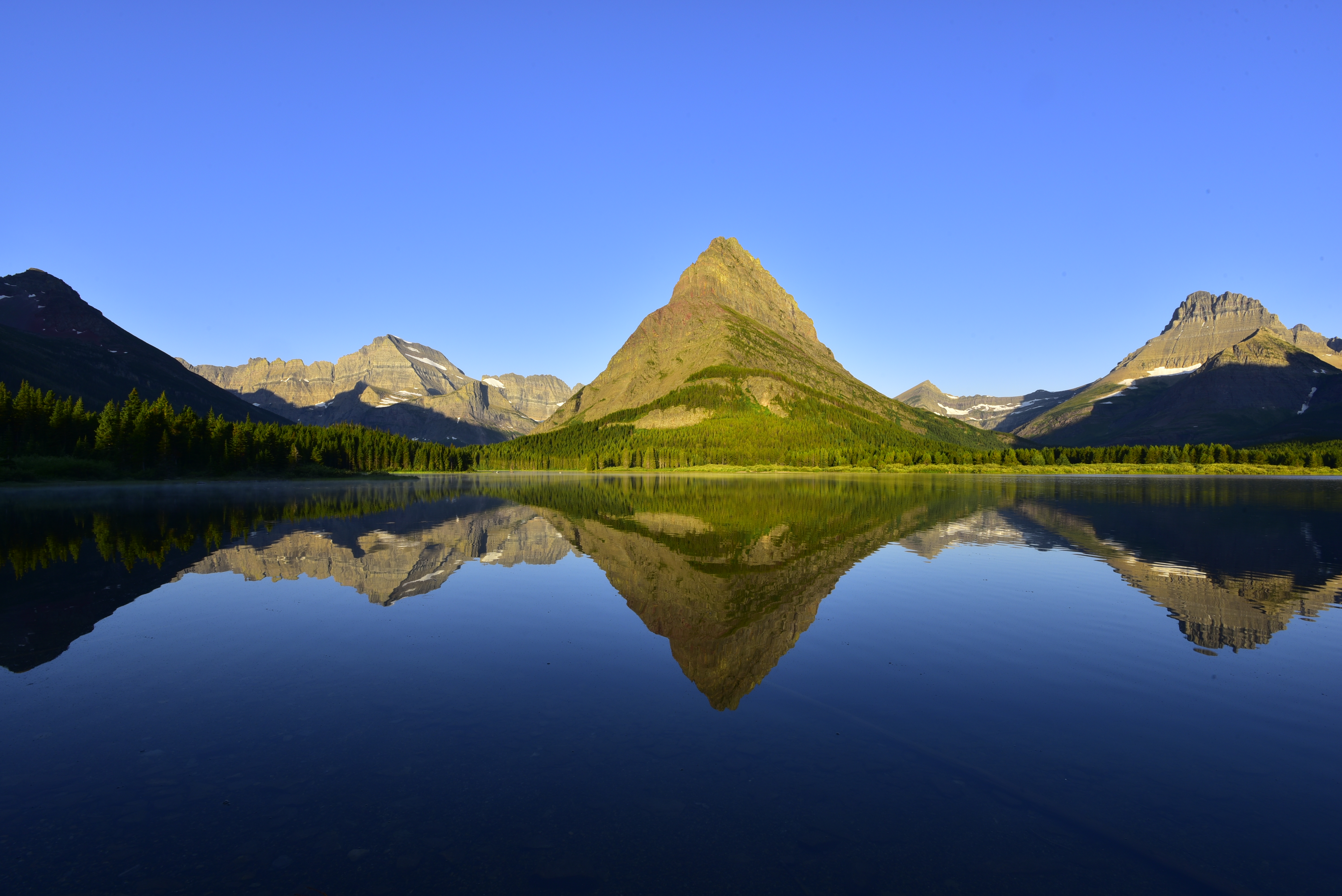 Early morning light, Swiftcurrent Lake, (left to right) Mt. Gould, Grinnell Point, Swiftcurrent Mountain, Mt. Wilbur   -  Glacier National Park, Montana 