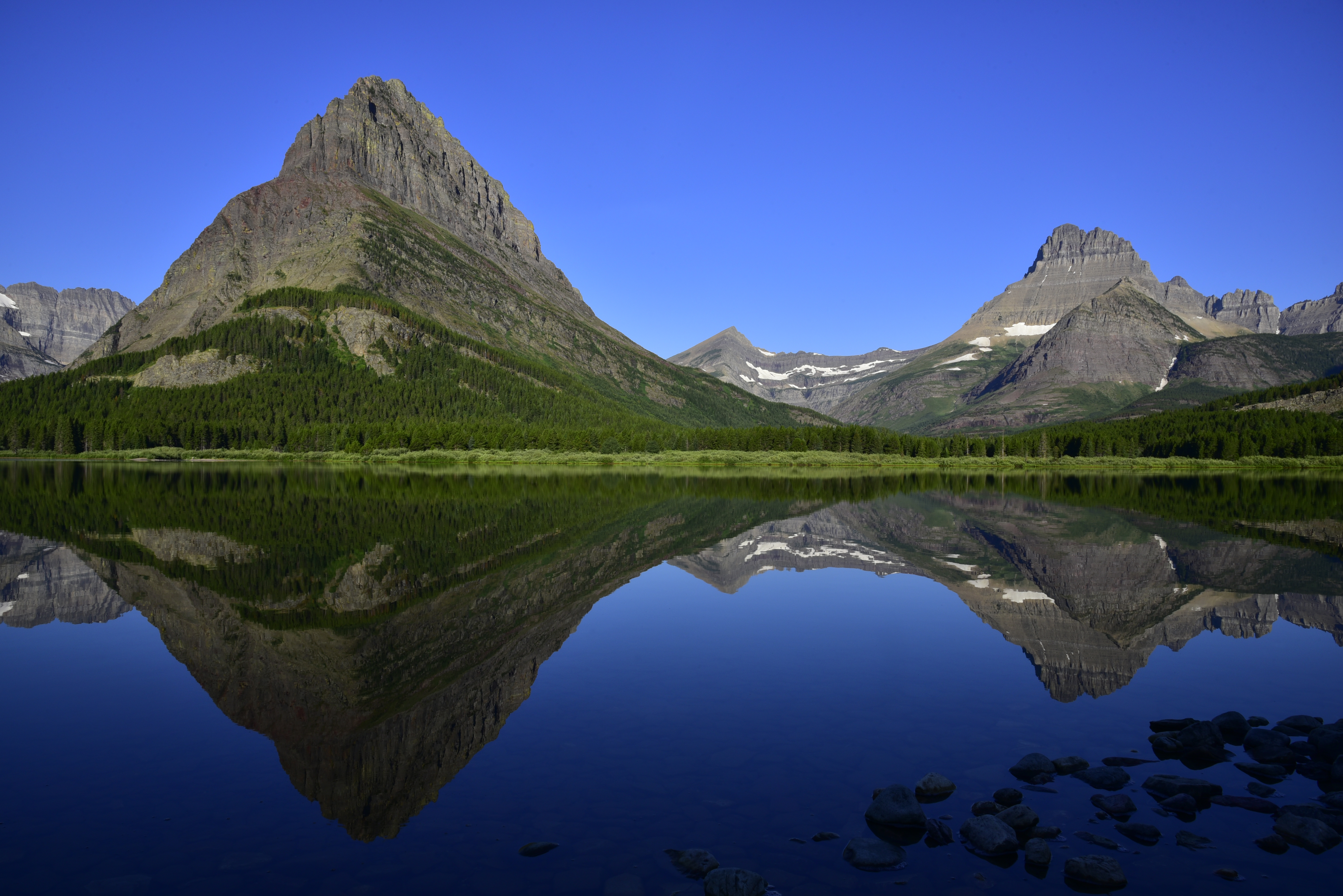 Early morning light, Swiftcurrent Lake, (left to right) Grinnell Point, Swiftcurrent Mountain, Mt. Wilbur  -  Glacier National Park, Montana