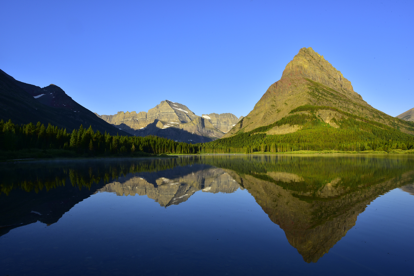 Early morning light, Swiftcurrent Lake: (left to right) Mt. Gould, Grinnell Point, Swiftcurrent Mountain  -  Many Glacier area, Glacier National Park, Montana