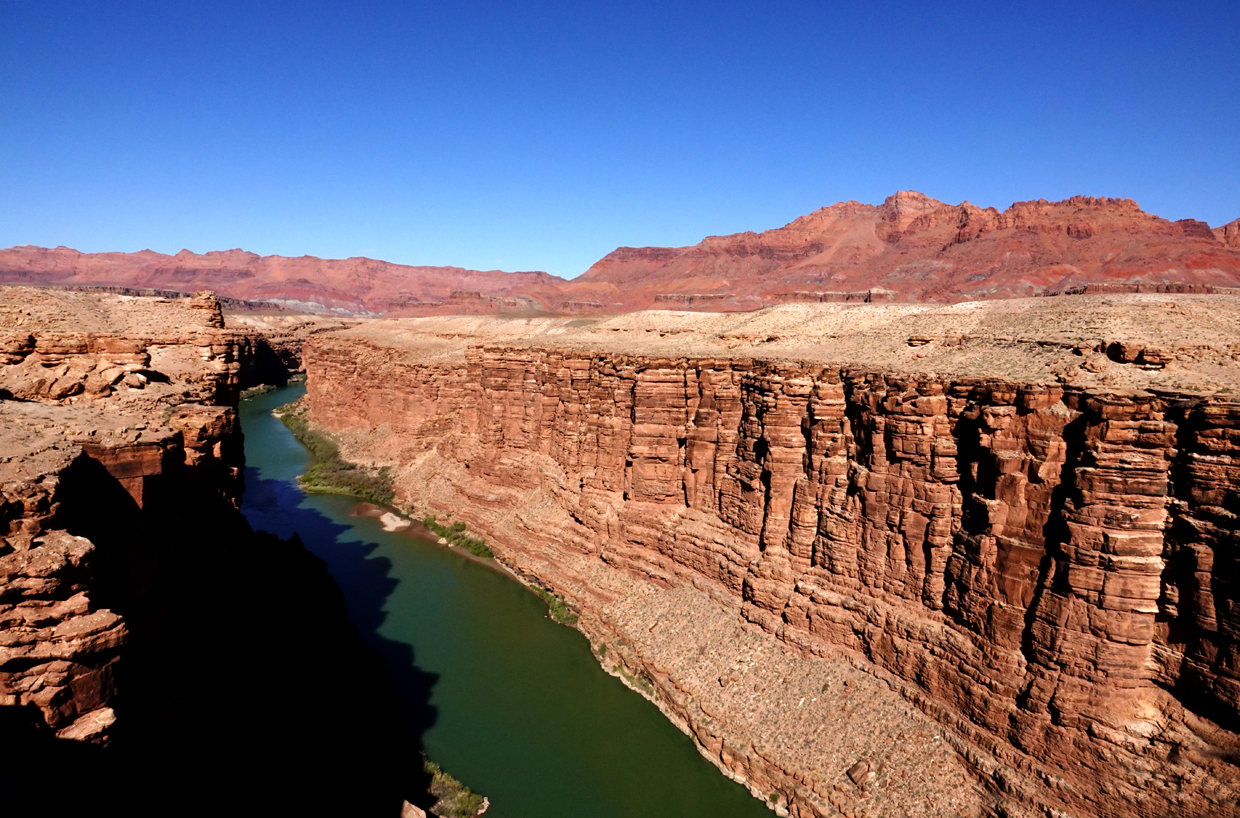 Colorado River  -  Navajo Bridge, Coconino County, Arizona --- Norman’s Note: This view of the Colorado River at 467 feet below was taken from the original steel span completed in 1929.  It is now a pedestrian-only bridge.